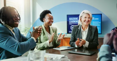 Three business professionals collaborating at a table, reviewing documents and discussing strategy.