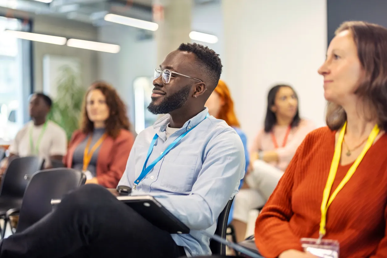 Attentive diverse audience listening during a conference in a bright room