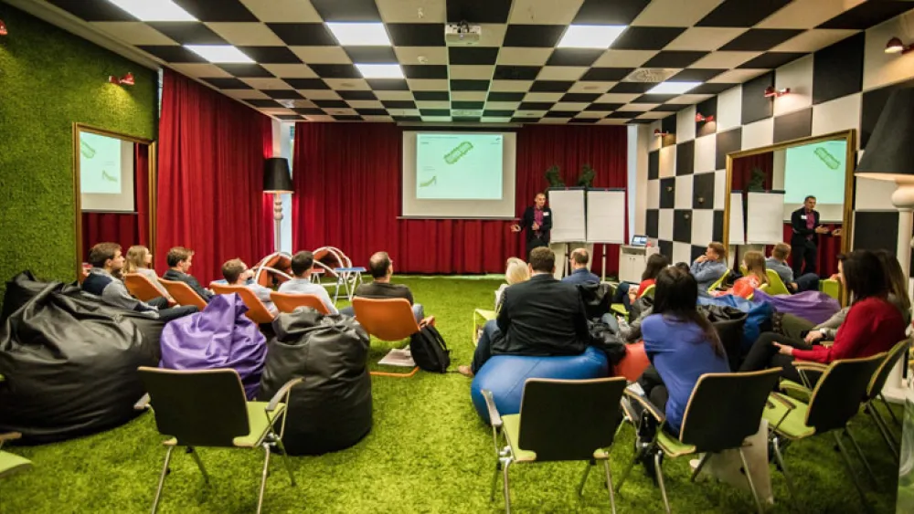 A Conlea classroom with a black and white tiled ceiling and carpet which looks like articificial grass