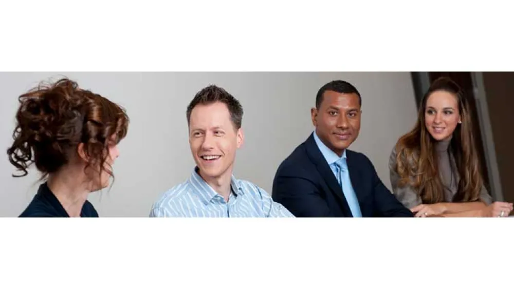 People smiling at a desk