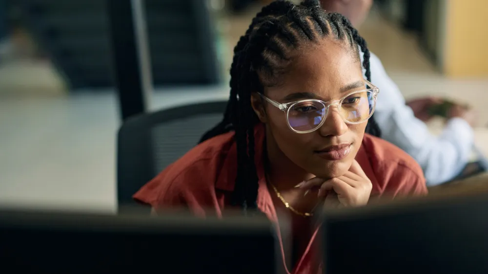 Woman studying computer screen