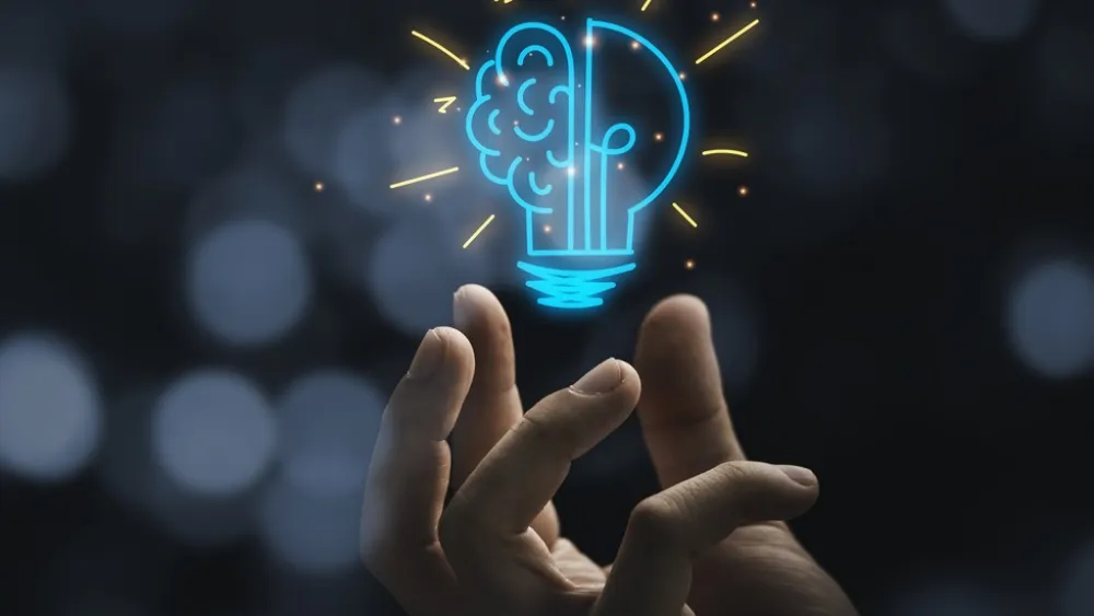 Main with light bulb and brain icon glowing in dark background