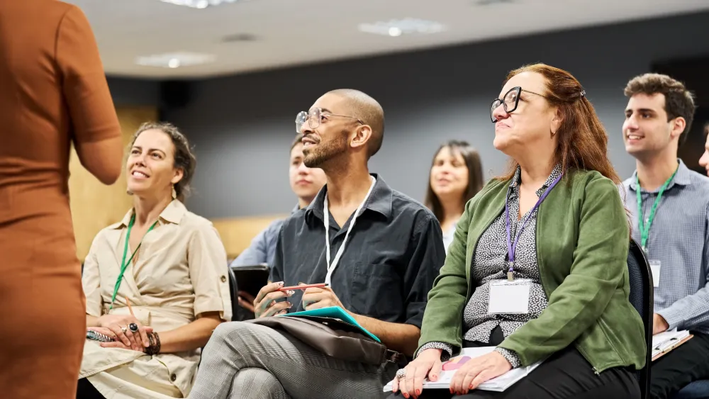 Group of diverse people sitting and attentively listening in a seminar room